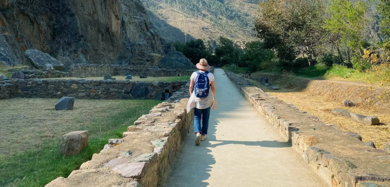 Tourist walking along a stone path in Ollantaytambo, Sacred Valley