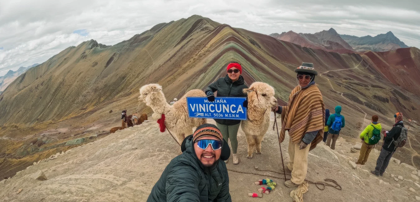 Hiker and snowy mountains on Rainbow Mountain full day tour from Cusco