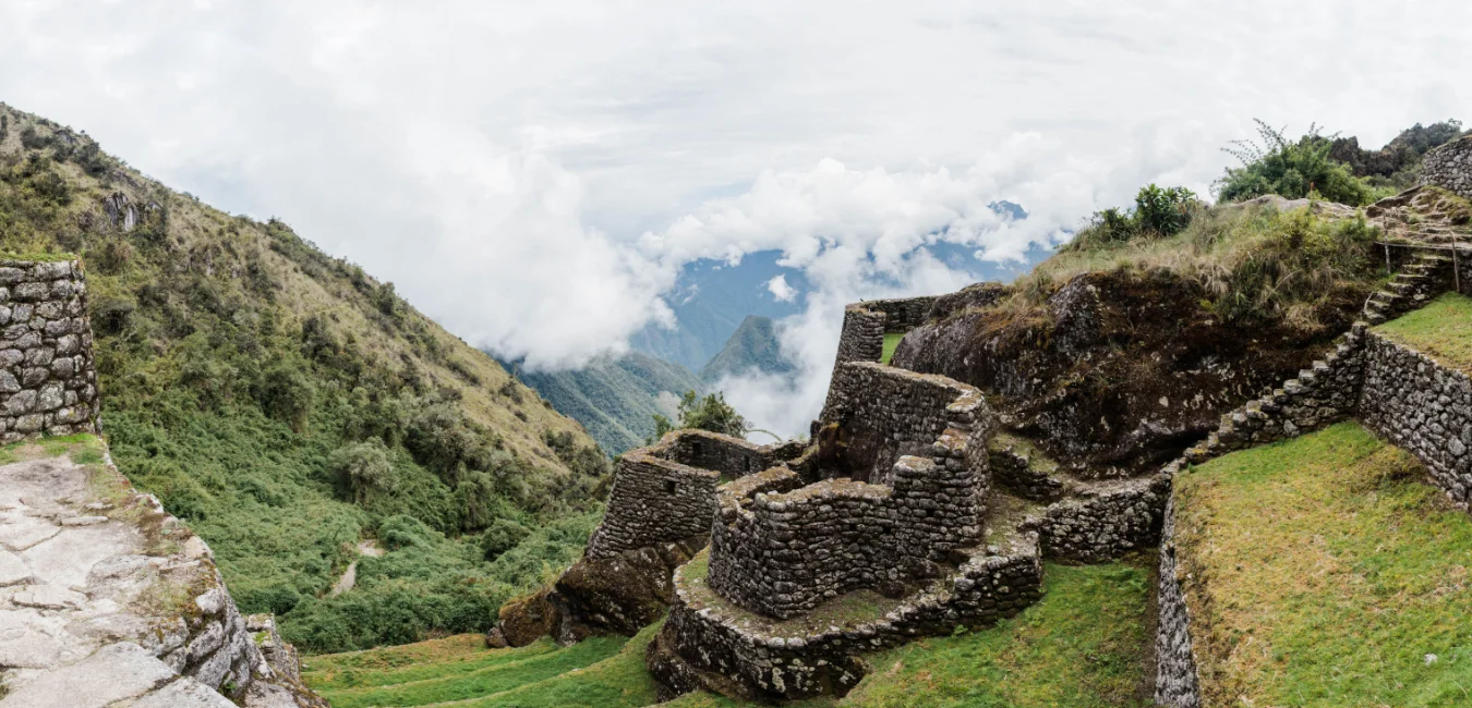 Ruins of Sayaqmarca along the Inca Trail, perched on a hillside with panoramic views.