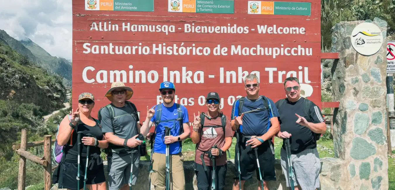 Starting point of the Inca Trail at Km 82, showing hikers beginning their trek through the lush Andes mountains toward Machu Picchu