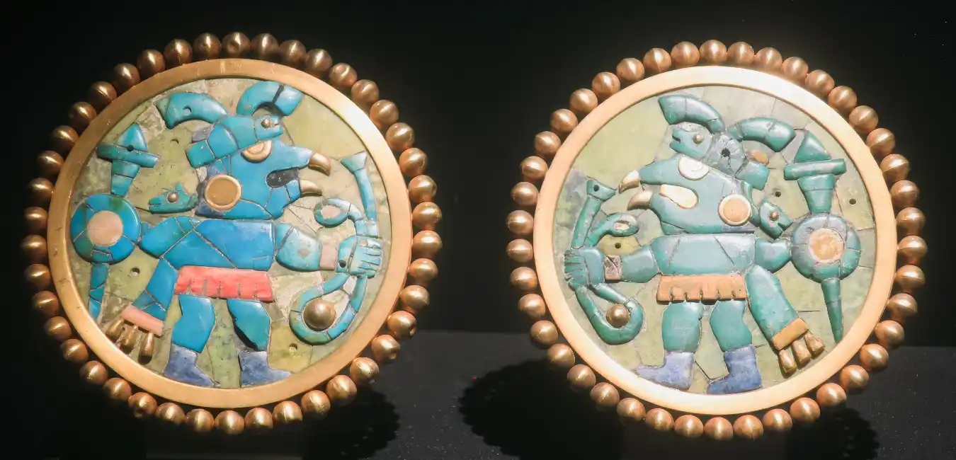Ancient Moche gold ear ornaments decorated with turquoise mosaic 