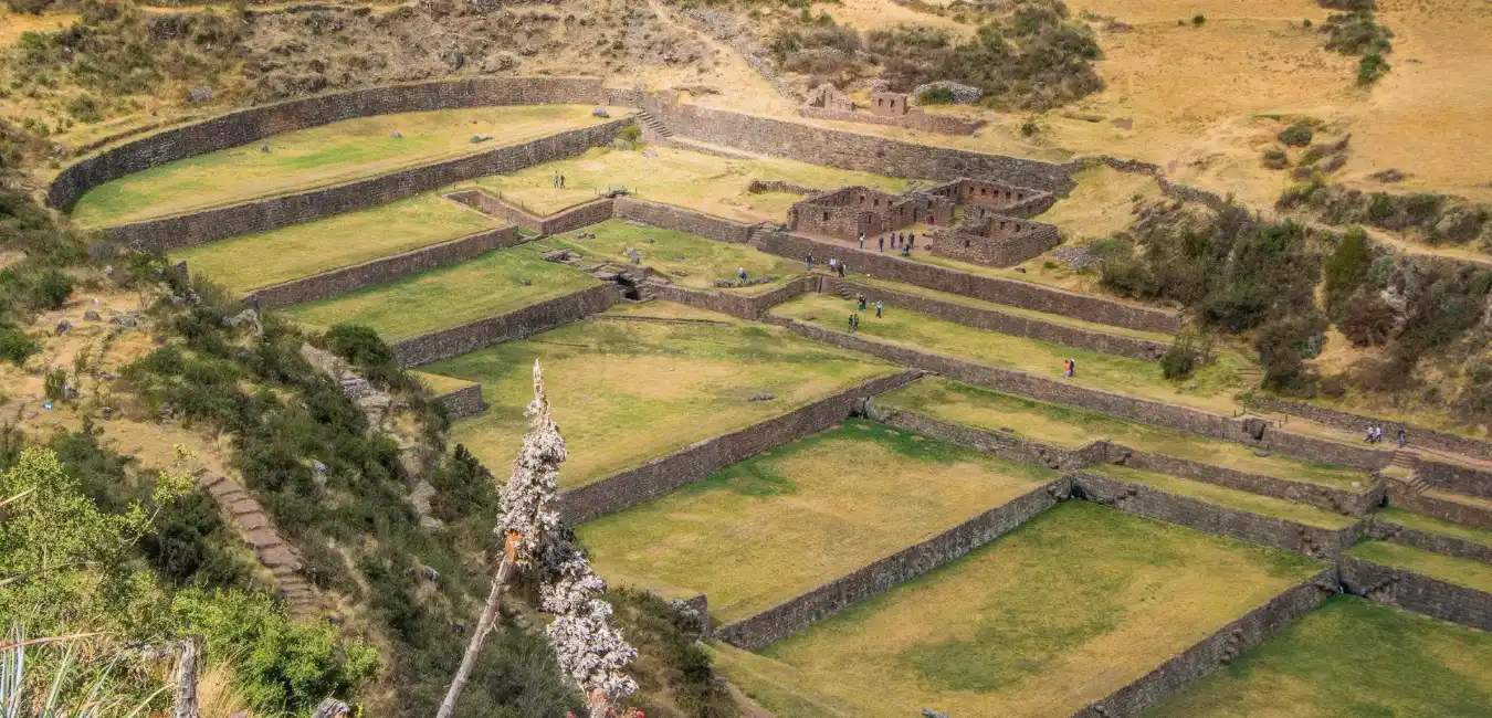 Panoramic view of Tipón archaeological park with Inca terraces and surrounding Andean landscape in Cusco