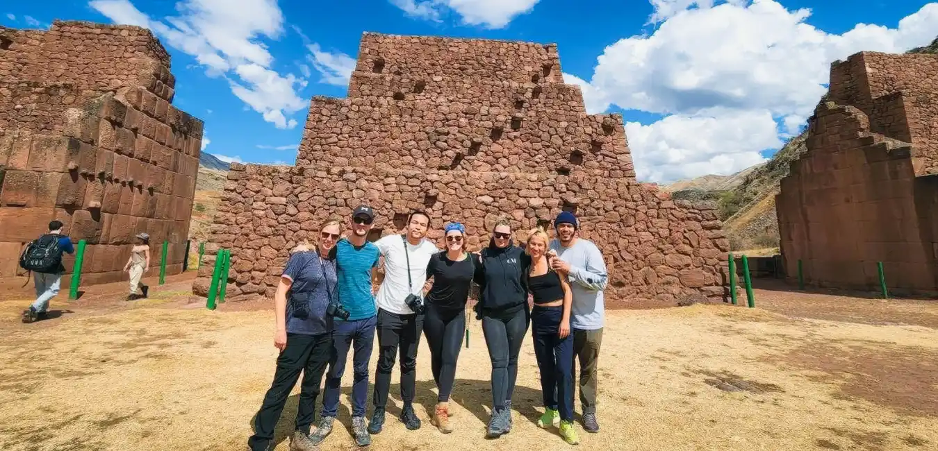 Tourists exploring the ancient Pikillacta archaeological site near Cusco