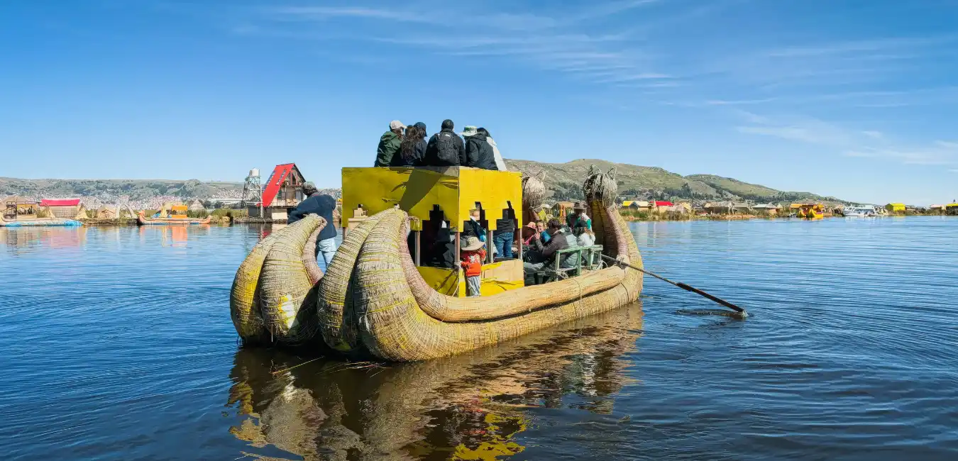 Tourists enjoying a traditional totora reed boat ride on Lake Titicaca near the Uros Floating Islands, Peru