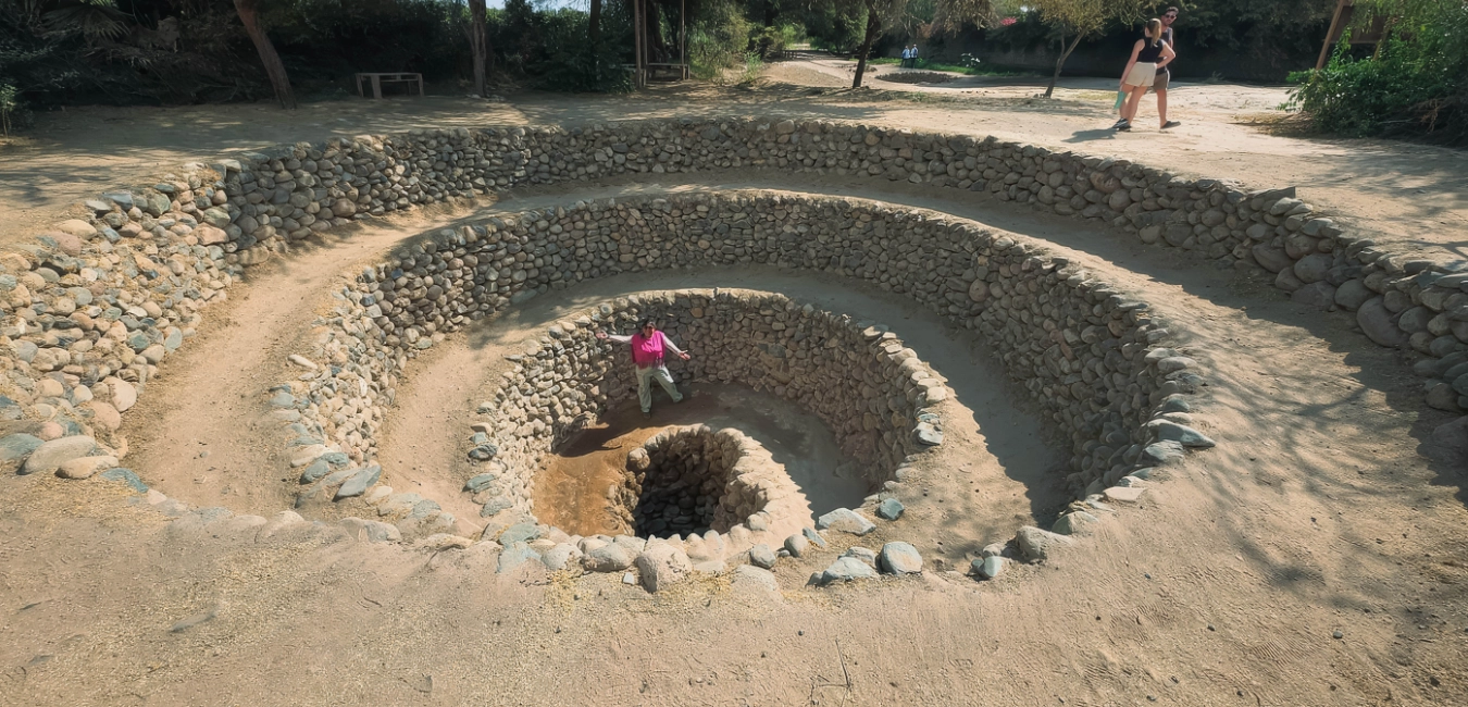 Female traveler standing inside a spiral well  