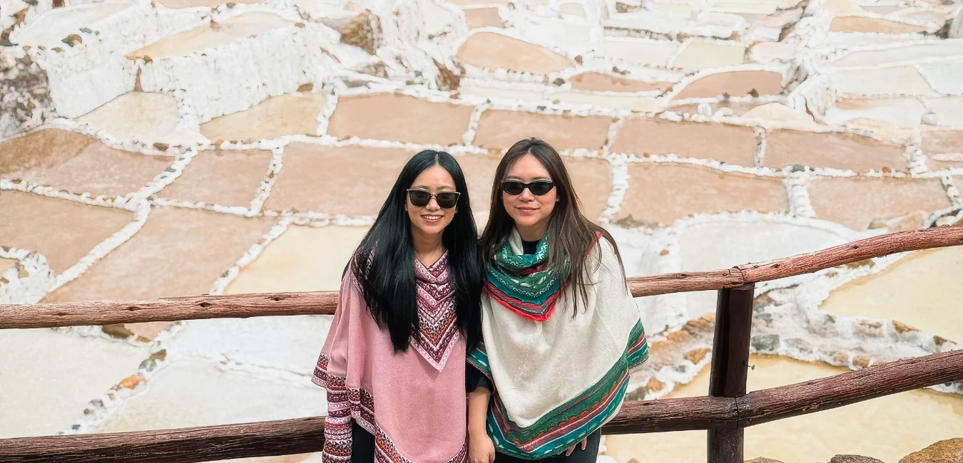 Two women standing at the Maras Salt Mines in Cusco