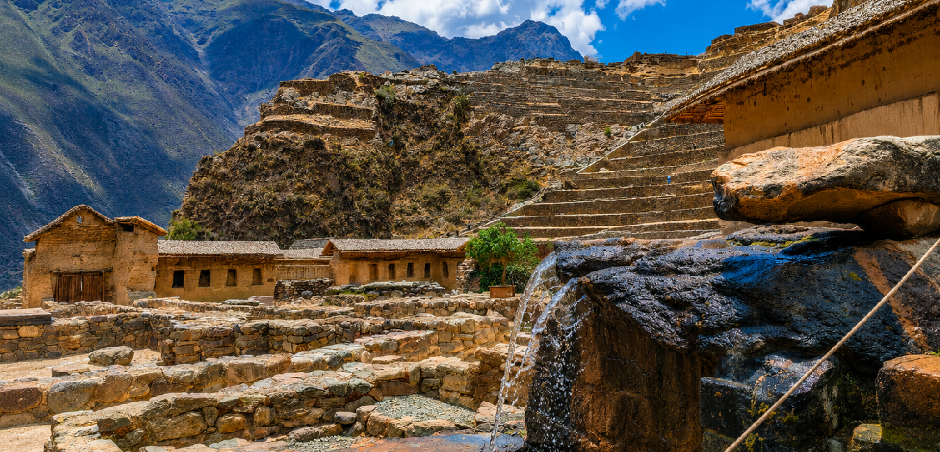 Ancient Inca terraces, stone water channel, and temple ruins at the Ollantaytambo archaeological site in Peru's Sacred Valley.