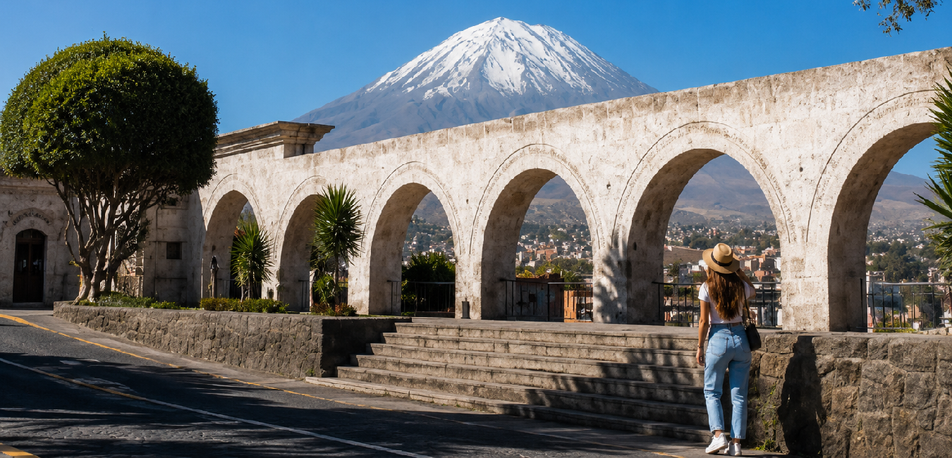 Tourist admiring the Santa Catalina Monastery arches with the snow-capped Misti Volcano in the background, Arequipa, Peru.