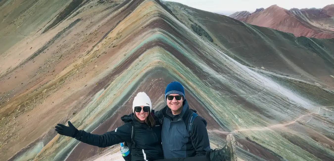 Tourist standing at the Rainbow Mountain viewpoint 