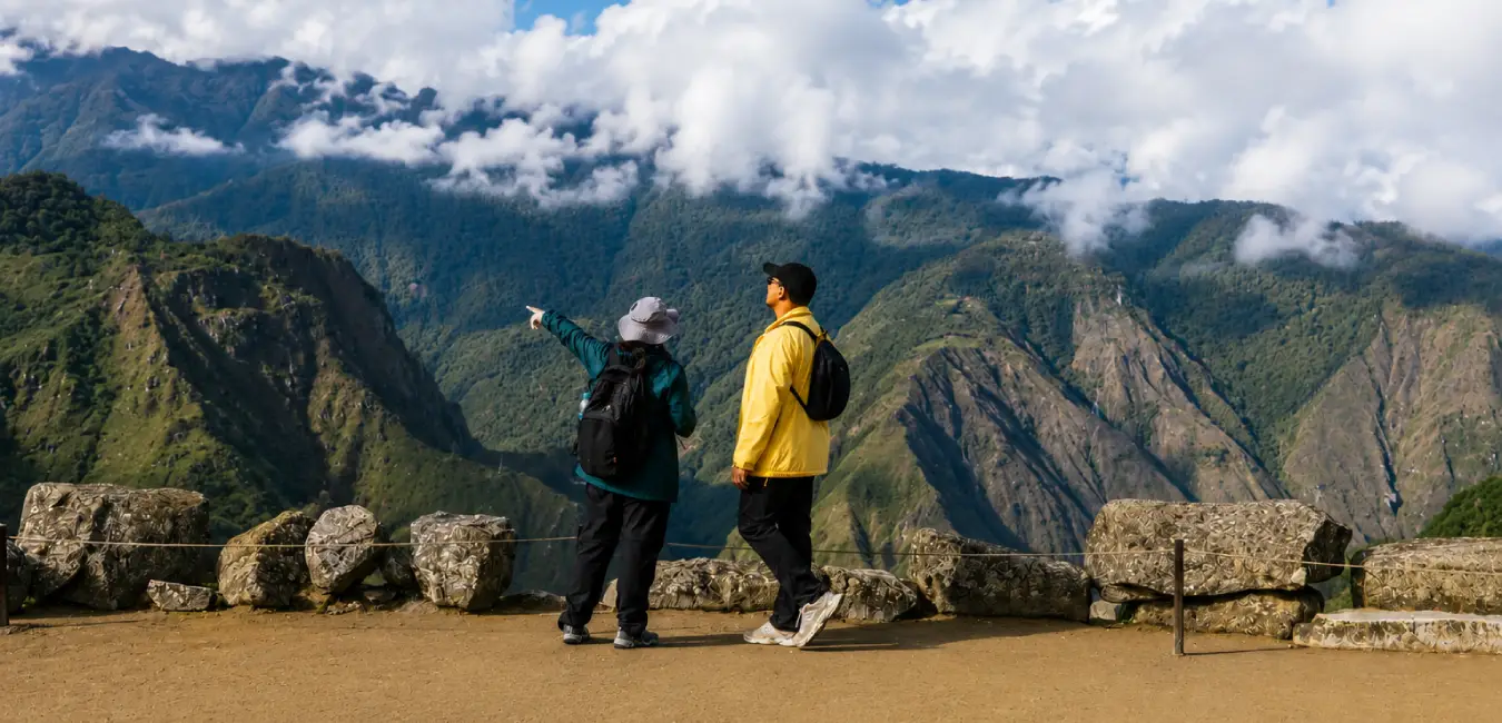 A tourist observing the location of the mountain the guide is pointing out.