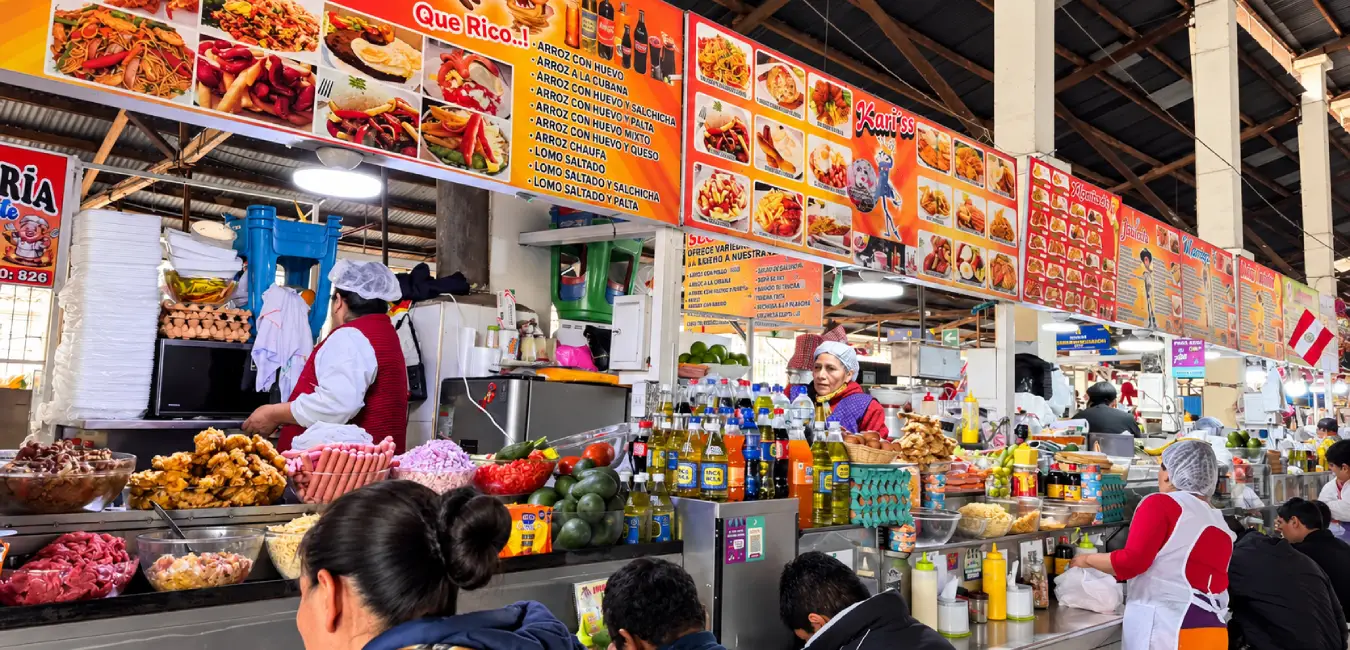 Sale of food and fried snacks inside the San Pedro Market in Cusco.