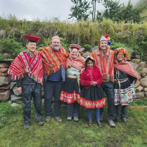 Travelers wearing traditional clothing during a community-based hike in Lares